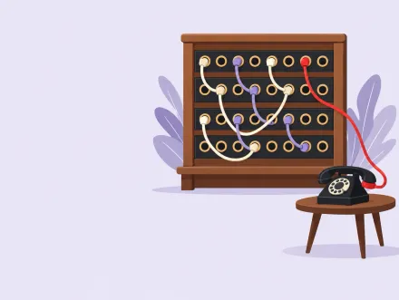 An old switchboard with patch cords linking lines to answers, and one red cord running to a waiting telephone.