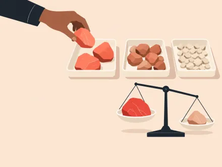 A hand sorts stones into three trays while a small balance scale weighs a large red stone against a smaller one.